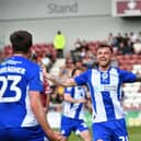 Dale Taylor celebrates his dramatic late leveller with James Carragher