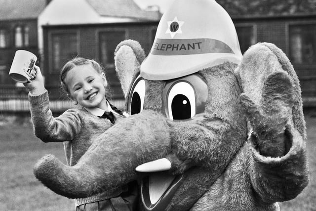 Fire Service mascot Welephant with Jennifer Raw a pupil at St. Peter's Primary School, Bryn, who won a fire safety slogan competition run by GMC Fire Service in February 1989.