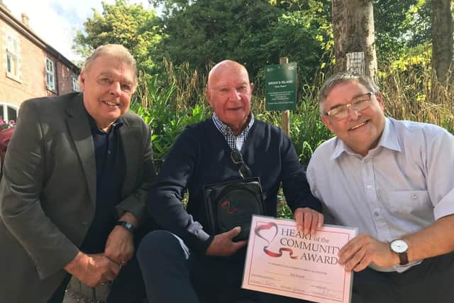 Volunteer Brian Muscroft receives the Heart of the Community Award from councillors Ron Conway and Chris Ready