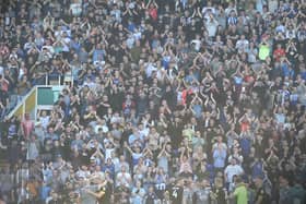 The Latics fans celebrate a famous victory at Birmingham