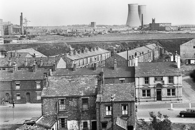 A view in the 1960s of Ormskirk Road, Newtown, in the foreground with the Saddle Inn on the right. In the background are Westwood power station, with Clifton Mills on the right and St. James church tower behind.