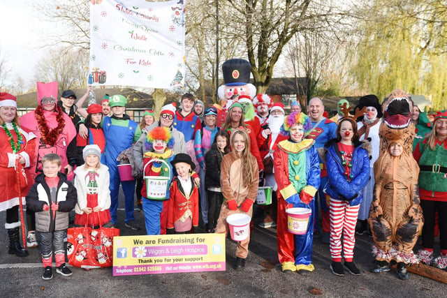 Group photo of charity fund-raisers in their Christmas fancy dress outfits.