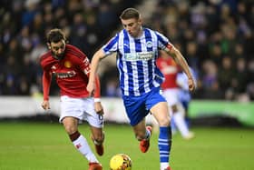 Charlie Hughes brings the ball out against United