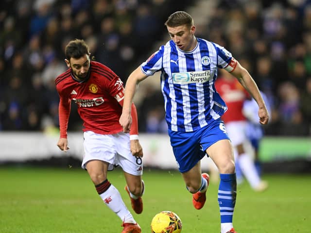 Charlie Hughes brings the ball out against United