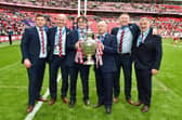 Wigan Warriors owner Mike Danson and his son with the Challenge Cup trophy