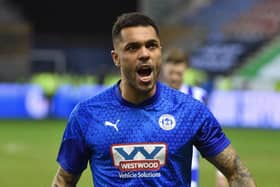 Josh Magennis has joined Gary Caldwell's Exeter on a 12-month contact following his release from Wigan