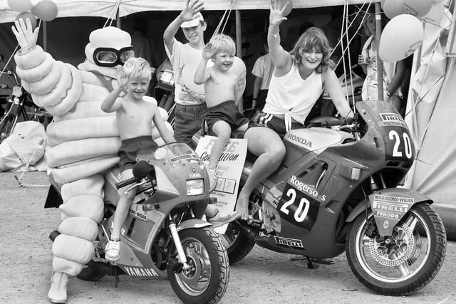 Enjoying a biker's fun day in aid of Wigan and Leigh Hospice at the Three Sisters race track, Bryn, with Michelin Man are Nerys Owen and brothers Derry and Noel Green on Sunday 19th of June 1988.