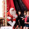 Santa taking Christmas wishlist orders.