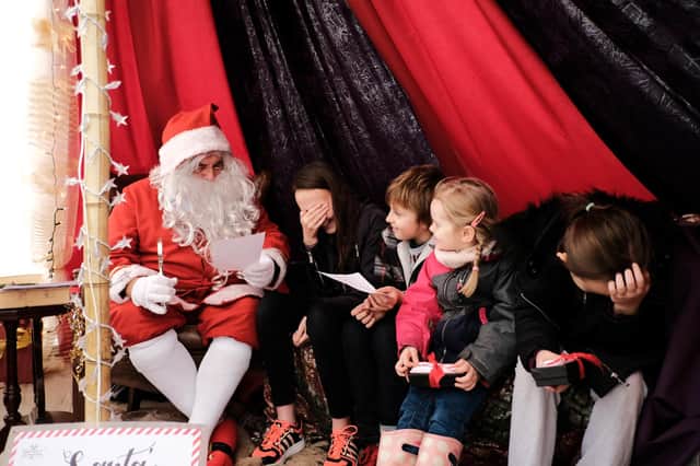Santa taking Christmas wishlist orders.
