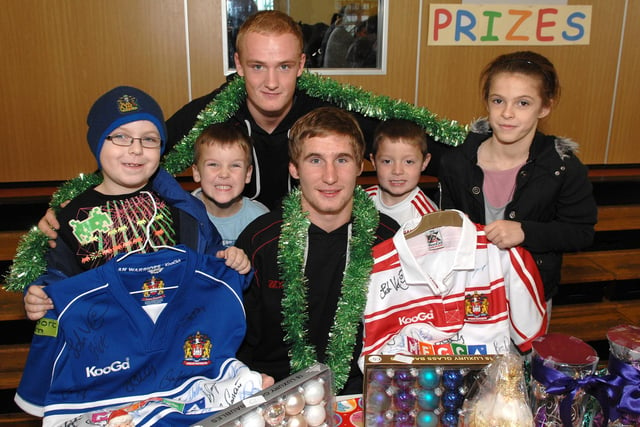 Wigan Warriors players Sam Tomkins and Stuart Howarth with pupils Liam and Leah Monk, Harry Parkinson and Matthew Birch at the St Cuthbert's Catholic Primary School, Norley Hall, Christmas Fayre, 2009.