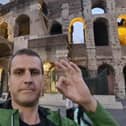 Chris Woodward does the Andy's Man Club hand gesture outside the Coliseum in Rome