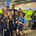 Wigan's Jack Farrimond played his junior rugby league at Leigh Miners Rangers, pictured above with the community club's current youngsters and Wigan Warriors head coach Matt Peet