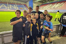 Wigan's Jack Farrimond played his junior rugby league at Leigh Miners Rangers, pictured above with the community club's current youngsters and Wigan Warriors head coach Matt Peet