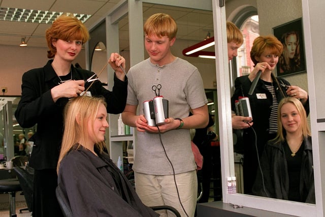 Norman Philip Hairdressers, on Wallgate, Wigan, with new exclusive revolutionary heated scissors. Pictured in the hot seat is model Claire Newton, 16, with stylist Liz Hinnigan and assistant Warren Bulpitt, 18
