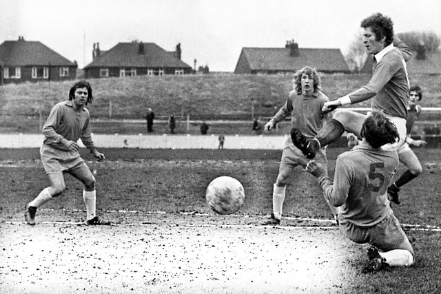 Wigan Athletic defender, Albert Jackson, joins the attack against Lancaster City in a Northern Premier League match at Springfield Park on Saturday 4th of January 1975 which Latics won 1-0 with a Micky Worswick goal.  On the left is former Latics player Micky Taylor.