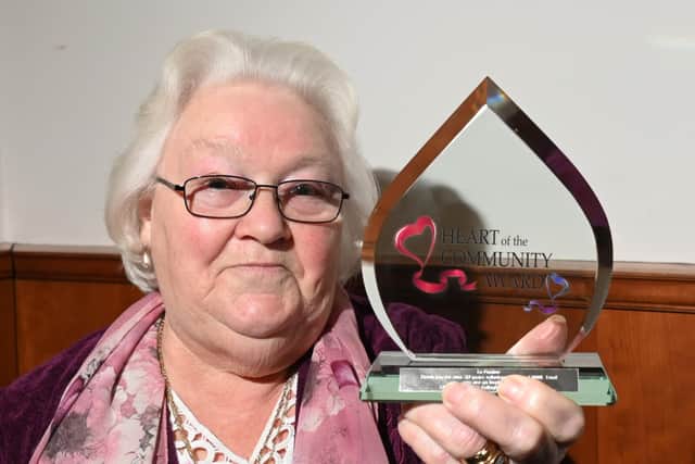 Pauline Carr is presented with the Heart of the Community Award