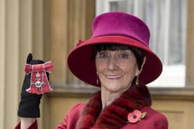 June Brown stands outside Buckingham Palace in London after receiving an MBE for services to Drama and Charity from Queen Elizabeth II.