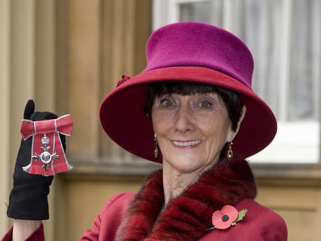 June Brown stands outside Buckingham Palace in London after receiving an MBE for services to Drama and Charity from Queen Elizabeth II.