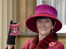June Brown stands outside Buckingham Palace in London after receiving an MBE for services to Drama and Charity from Queen Elizabeth II.