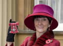 June Brown stands outside Buckingham Palace in London after receiving an MBE for services to Drama and Charity from Queen Elizabeth II.