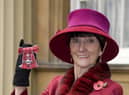 June Brown stands outside Buckingham Palace in London after receiving an MBE for services to Drama and Charity from Queen Elizabeth II.