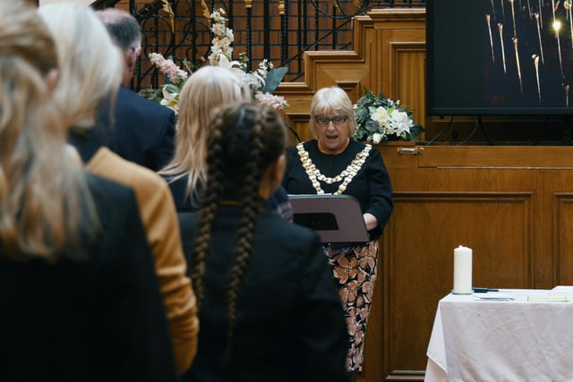 The Mayor of Wigan Coun Marie Morgan lights the Peace Candle and reads the Statement of Commitment.