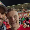 Ryan Reynolds celebrates on the pitch at Wrexham with Paul Mullin