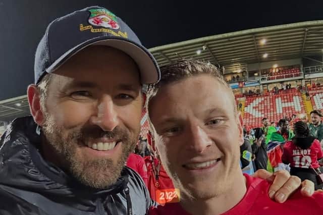Ryan Reynolds celebrates on the pitch at Wrexham with Paul Mullin