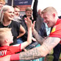 James McClean celebrates with family after Latics clinched the League One title at Shrewsbury at the end of the 2021-2022 season