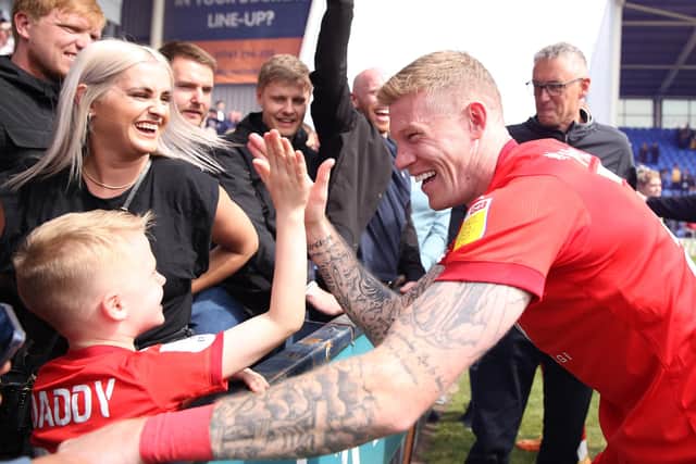James McClean celebrates with family after Latics clinched the League One title at Shrewsbury at the end of the 2021-2022 season