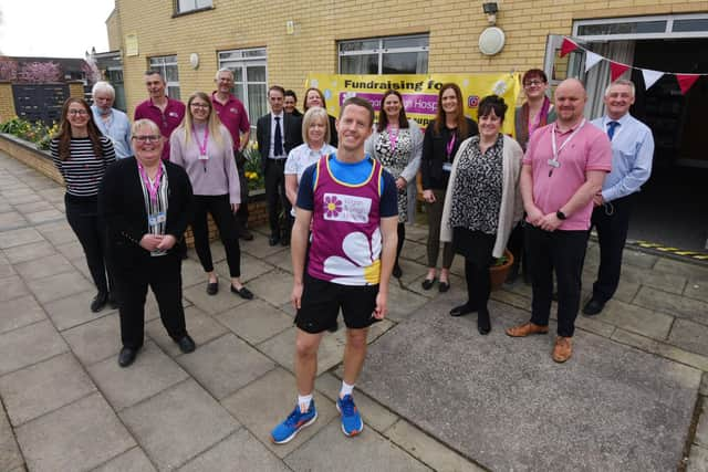 Martin Foster with staff at Wigan and Leigh Hospice