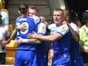 The Latics players celebrate James McClean's opening goal