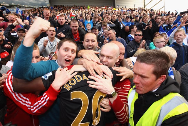 Hugo Rodallega celebrates staying up and victory with the fans during the Barclays Premier League match between Stoke City and Wigan Athletic