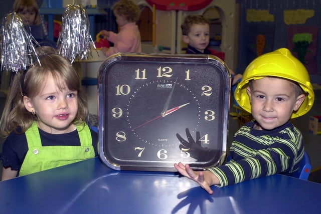 2000 - Laura Slater and Joseph Gaskell from Kids.Com Nursery at Springfield, getting the class clock ready to change at the weekend.