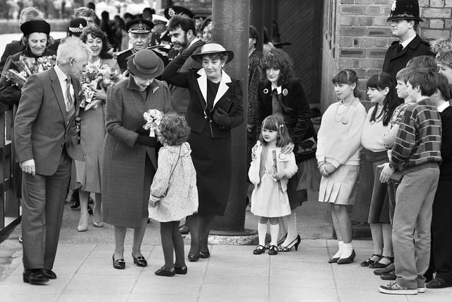 A big moment for a little girl.....she dashed out of the crowd on the Heritage Centre forecourt to present a posy to the Queen, Wigan Pier, 1986