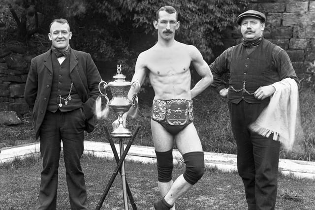 Champion Wigan wrestler, Bob Berry, with manager, Will Bennet, left, and trainer J. Stockley in the early 1900s.