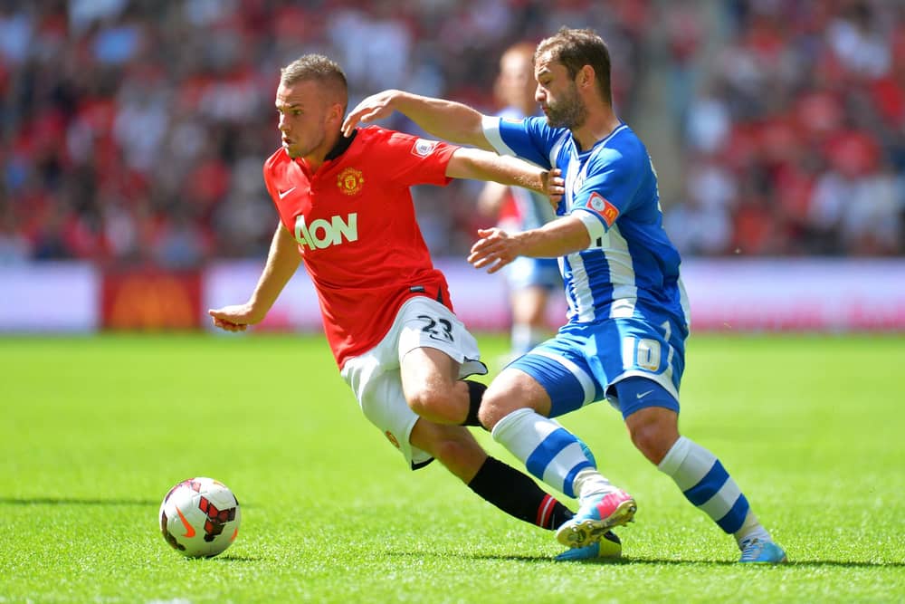 Tom Cleverley battles Shaun Maloney during the 2013 Charity Shield between Manchester United and Latics