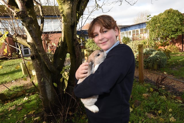 Pupils with one of the Reading Rabbits, who love to listen to pupils read and support wellbeing.