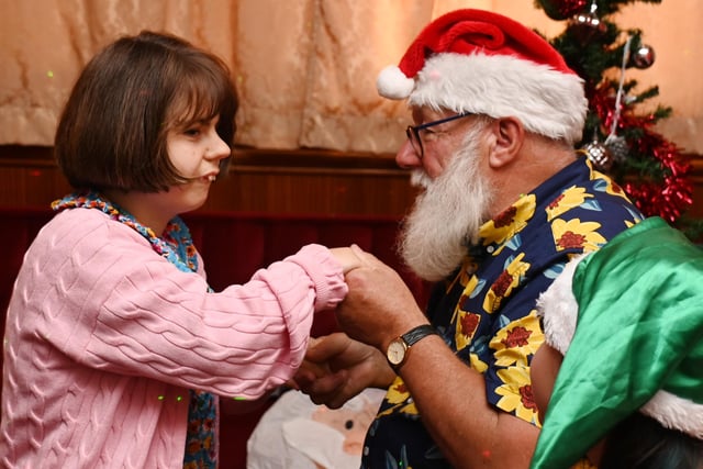 Santa on his summer holidays, met children at the Christmas party event.