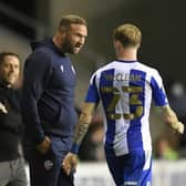 Ian Evatt has a chat with James McClean during Latics' Carabao Cup victory earlier in the campaign