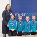 Members of the 3rd Wigan Scouts celebrate receiving a grant from Miller Homes
