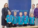 Members of the 3rd Wigan Scouts celebrate receiving a grant from Miller Homes