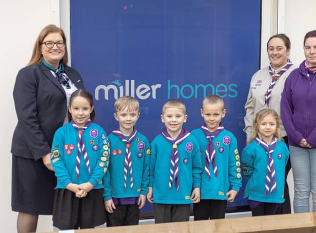 Members of the 3rd Wigan Scouts celebrate receiving a grant from Miller Homes