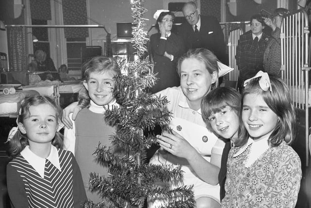 Orrell schoolchildren present a Christmas tree to Wigan Infirmary in 1973.