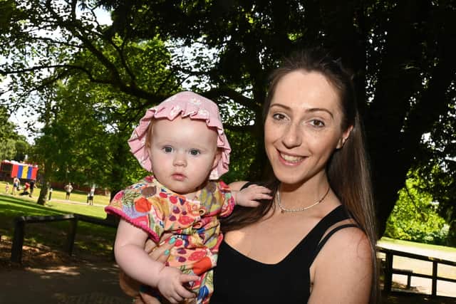 The sun shines at Haigh Woodland Park.  Amy Roberts with 10-month-old Dorothy, seek the shade on another hot September day