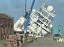 A ship is currently leaning towards the docks at a worrying angle in Leith, Edinburgh. (Photo credit: @Tomafc83 on Twitter)