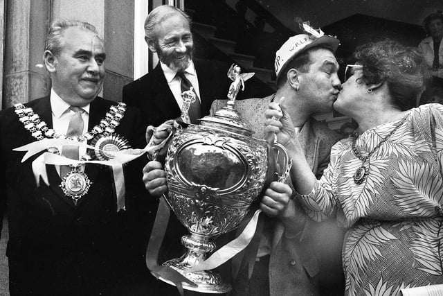 A Nicky kiss.....Wigan hooker Nicky Kiss steals a peck off mayoress Doris Jones watched by the mayor Coun. Jimmy Jones and Chief Executive Philip Johnson on the town hall steps as the team arrived for a civic reception on Sunday 1st of May 1988 after their Wembley triumph. 