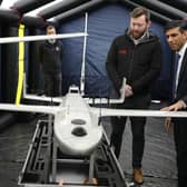 Prime Minister Rishi Sunak speaks with staff as he views a drone used for surveillance of vessels in distress, during a visit to the Home Office joint control centre in Dover