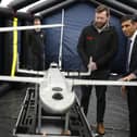 Prime Minister Rishi Sunak speaks with staff as he views a drone used for surveillance of vessels in distress, during a visit to the Home Office joint control centre in Dover