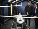 Prime Minister Rishi Sunak speaks with staff as he views a drone used for surveillance of vessels in distress, during a visit to the Home Office joint control centre in Dover